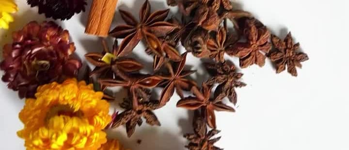 Botanicals pressed into a Candera candle, poured by hand
